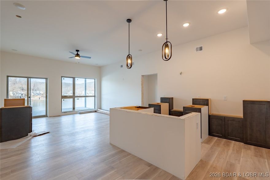 Experience refined lakefront living in this brand-new first-floor lockout unit at Ember Ridge, built with steel-frame construction for durability and long-term peace of mind. This 3-bedroom, 3-bath, new-construction condo features a third-bedroom lockout option, offering excellent flexibility for guests, owner use, or rental income. Convenient elevator access to the first floor. The thoughtfully designed layout allows the lockout suite to function as a private third bedroom with its own bath and kitchenette —ideal for maximizing income potential while maintaining owner privacy.  With modern finishes and a great lakefront location, this unit is well suited for a primary residence, weekend retreat, or investment property. Ember Ridge delivers a smart, stylish way to live on the lake.