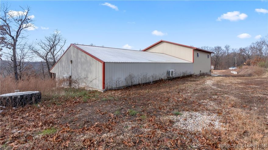 Discover this exceptional 4,000 sq ft Shouse/commercial/industrial shop at 835 Greenview Dr in Camdenton.  Located in Greenview just a few miles off of Highway 5.  Situated on a flat 8.11 acres with no restrictions or subdivision requirements. Perfect for an RV, storage, commercial business, or building a Shouse/residence, there is plenty of room to build and expand. The land is also suitable for recreational activities and hunting. Built for heavy use, the shop features two spacious 14' garage doors and 21' ceilings. It is equipped with 480-volt, 3-phase electric and a new mini-split system providing heat and air conditioning. The facility boasts extra-thick 8-inch concrete floors and a matching driveway, both poured with a durable 7 sack mix. Utilities include a shared well and a 1000-gallon septic system, making this property versatile for demanding operations or a unique live/work setup.