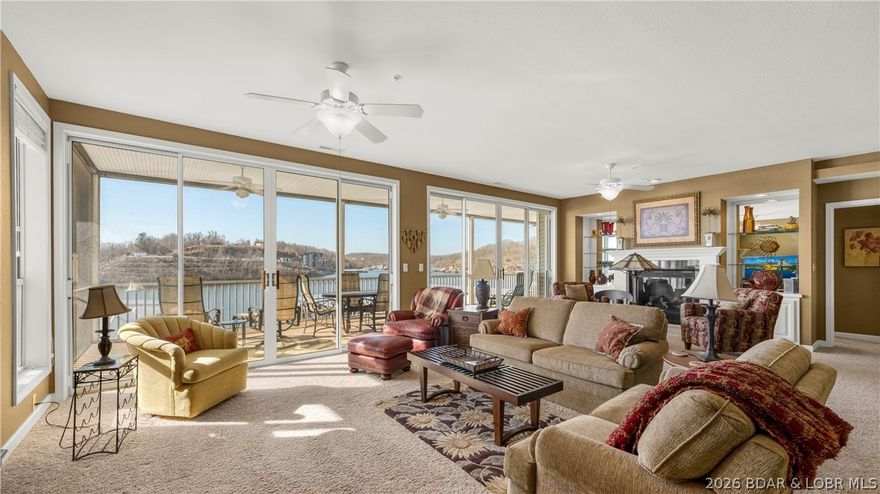 Huge screened deck, 12x32 boat slip with 8,000 lb lift, and rare 3 bedroom, 3.5 bath layout with 2,084 sq ft at Summer Place on the 35 MM of the Osage. This spacious single-level condo features an open kitchen, dining, and living area with a breakfast bar and gas fireplace, creating an easy flow for entertaining or relaxed lake living. The oversized south-facing screened deck runs the full length of the condo and captures peaceful cove water with main channel views. Each bedroom has its own private bath, giving family and guests comfort and privacy. Sold fully furnished for a simple move-in experience. The dock sits directly in front of the building, and the elevator at the front door takes you straight to the dock level for an easy walk to your slip. Summer Place is known for its beautifully maintained grounds and welcoming community feel, offering two pools, hot tub, clubhouse, pickleball courts, and a new workout room. Conveniently located near Captain Ron’s and Bear Bottom Resort. Open parking plus an optional one-car garage available for $35,000.