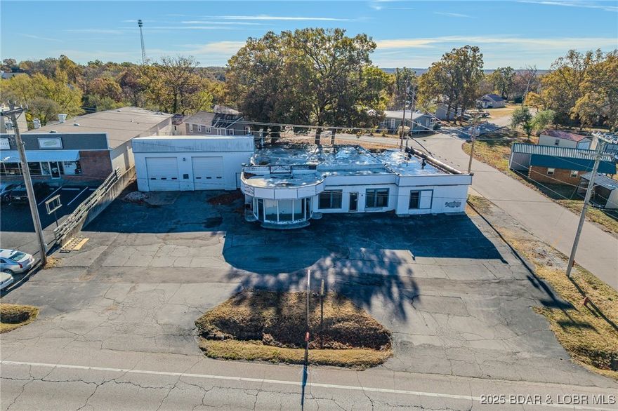 Camdenton, MO. Very Enticing 125 Feet Hwy Frontage + 254 Side Street Frontage on W Highway 54 just 3-4 Blocks from a growing Town Square. Traffic Count is 16,549 Vehicles per Day. On an 0.373 Acre Corner Lot which Includes a Commercial Approx 6,438 SqFt Building on Level Land w/ a Large Parking Lot & the Back Flat Vacant Parcel that could be used for Additional Parking or Building Expansion is available for RENT. Formerly an Auto Garage/Station (See completed DNR Phase 2 Tank Removal Reports in attachments). Great Visibility w/ Easy Access. So Many Possible Uses: Retail, Office Building, Auto or Marine Garage/Sales, Restaurant, Medical, Rental Property, Supply Storage Building, etc. Commercial Building includes: Large Reception Area, Glass Atrium Display Room, Large Office Area, 3 Different Shop Areas with 3 Large Commercial Garage Doors, Storage Areas, Sump Pump, Drains in Floors of Shop Areas. (Back Wall needs some Work- see Foundation Recovery BID in attachments). Ceiling Heating Units have been removed from all 3 shops. Zoned Commercial. Great Opportunity. *You Must See the Extra Feature Sheet in Listing Attachments*