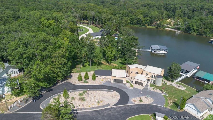 Luxury lakefront home located in a highly sought-after cove at Lake of the Ozarks, offering a private dock, indoor pool, and excellent entertaining spaces. This fully furnished, recently updated 5-bedroom property features an open-concept layout with expansive lake views and quality finishes throughout.
The main living area flows into a well-appointed kitchen with premium appliances, custom cabinetry, and solid surface countertops. Notable interior features include a spiral staircase, marble flooring, and updated lighting.
The walk-out lower level provides additional living and entertaining space, along with an indoor swimming pool for year-round use. A private guest suite with full bath offers added flexibility for hosting.
Exterior highlights include a custom outdoor kitchen and a private dock with an 18x50 slip and PWC lift.
Recent updates include a brand new roof with a 15-year transferable warranty, new marble flooring, updated lighting and more.
Ideal for full-time living, a second home, or investment property.