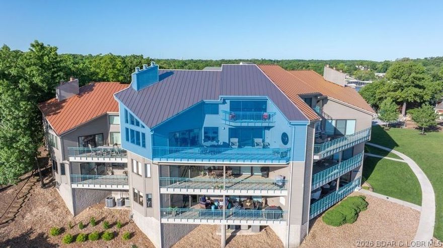 PENTHOUSE! 24 foot ceiling and breathtaking views. This is not your average condo!! With only 10 units in the complex. Top Floor  Lakefront Condo on 20 mm of Lake of the Ozarks offering 4 bedrooms and 4 bath with a extra bunk room. Remodeled and decorated with modern touches. Every bedroom offers its own bathroom and closet. Main channel balconies offer stunning views. Assigned parking guarantees you private parking upon arrival and the swimming pool is a very short walk. Only minutes away from the Hospital, Airport, and many restaurant's. Come see today!