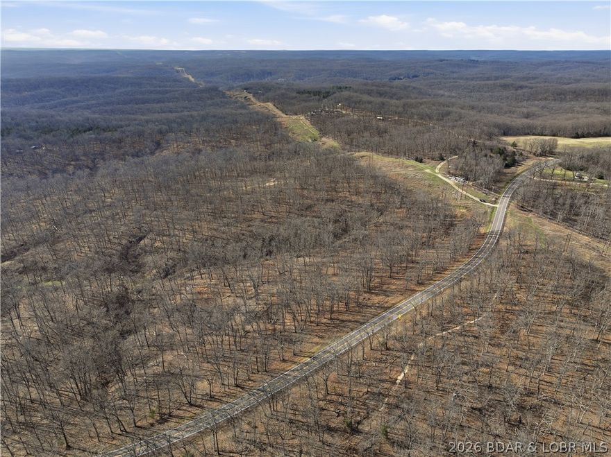 This 70-acre property is ideal for constructing a custom residence. The area boasts plentiful deer and turkey, making it great for hunting or simply observing wildlife. A utility line borders the land. The Lake of the Ozarks is in close proximity, providing outstanding fishing opportunities.