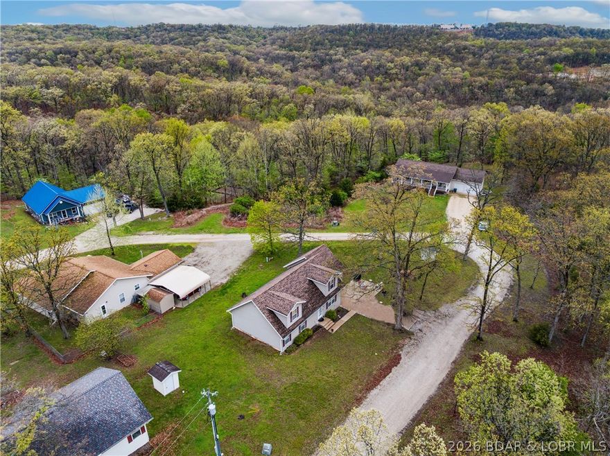 Fresh opportunity for this 4-be, 3-bath home offering over 2,000 square feet with a layout that gives you flexibility—main level living with additional bedrooms upstairs for guests, kids, or a dedicated work-from-home setup. The living room flows comfortably into a generously sized kitchen. Bedrooms are well-proportioned, and the overall footprint makes practical sense for everyday use. Recent updates include a newer roof and gutters, giving buyers added peace of mind where it counts. Upstairs, you’ll find two large bedrooms offering impressive square footage—ideal for creating oversized guest rooms, bunk spaces, or hobby areas. These spaces present a great opportunity for a little TLC and personal customization to truly make them your own. The attached garage adds functionality. Set on a manageable lot in a quiet, established neighborhood, the property is conveniently positioned with easy to local hot spots like Paradise restaurant and everything the Westside offers and its just a quick jaunt over the Community Bridge to all Osage Beach/Lake Ozark amenities. With your own finishing touches, this is worth a look at its new price point.
