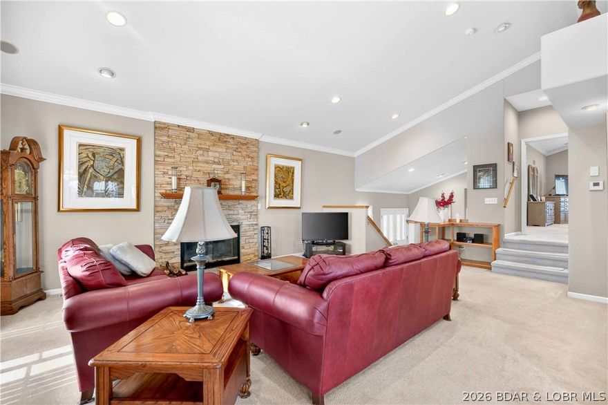 Offered for the first time by the original owner, 6835 Saint Tropez Circle is an immaculately maintained Lake of the Ozarks retreat in Osage Beach with a beautiful lake view. Set on .62 acres, this 4BR/2.5BA home offers over 3,000 sq ft and a multi-level layout with a walkout lower level; giving everyone room to spread out, gather, and make memories. Inside, cozy evenings are easy with a wood-burning fireplace, while weekends naturally drift outdoors to the covered, screened deck; then out again to the open portion designed for grilling, lounging, and soaking in those sunset skies. And when it’s time for a lake day, your 10x30 boat slip on the community dock sits just below the community pool, making it simple to go from a quick swim to a cruise in minutes. A rare St. Tropez opportunity - first time on the market and ready for its next chapter.