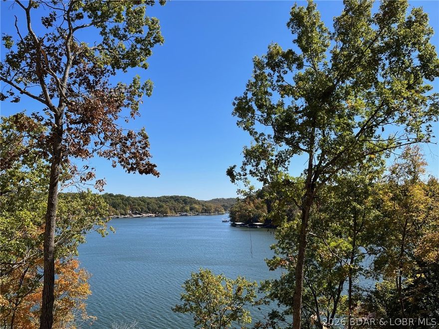 Imagine waking up to 100 feet of your own shoreline on Lake of the Ozarks, tucked into a big, quiet cove with deep, calm water. This property is ready for your vision with sewer and high-speed internet already available, plus plenty of space for your private dock. Surrounded by quality homes in a more secluded setting, you’ll enjoy the peace and privacy—yet still be just a short boat or drive away from some of the lake’s best dining spots. Located only 12 air miles from Bagnell Dam, you’re close to everything while feeling a world away. Build your lake life here. Adjoinging 100' lake lot # 6vailable for $110,000. MLS#3583498