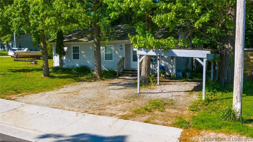 Located in the heart of Osage Beach, this property offers one of the best in-town locations at the Lake! Less than a mile from grocery stores, shopping, restaurants, entertainment, the Osage Beach Library, new Bass Pro development & quick access to Hwy 54. Newly installed sidewalks throughout Osage Beach Rd make getting around even more convenient. Situated on a large, level corner lot, this 1-story home features 2 bedrooms, 1.5 baths, carport parking & 2 newer mini-splits for efficient heating/cooling. Ideal as a starter home, downsizing option or investment property. Just off the entrance is a bright sitting room perfect for an office, craft room or flex space. Primary bedroom includes attached bath, plus an additional half bath near kitchen/living room. Flat fenced backyard offers a storage shed plus a finished “tiny house” style outbuilding with new insulation, flooring & mini-split; full bath & kitchenette is plumbed & ready to complete. No HOA & low taxes!