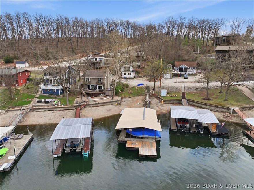 Welcome to your ideal Lake of the Ozarks retreat located in the highly sought-after Horseshoe Bend area, just minutes from Bagnell Dam Blvd. Perfectly positioned for convenience by both land and water, this turn-key home offers the ultimate blend of lifestyle and investment opportunity. Whether you are searching for a full-time residence, vacation getaway, or income-producing rental, this property checks every box with no rental restrictions in place. The home is move-in ready and designed for low-maintenance lake living, allowing you to start enjoying everything the lake has to offer from day one. Step outside your back door and enjoy immediate lake access with a boat slip in the community dock, located just steps from the home—making it effortless to get on the water at any time. Spend your days cruising the lake, dining waterfront, or relaxing with friends and family. Located in the heart of Lake of the Ozarks, this property offers unmatched proximity to shopping, dining, entertainment, and popular waterfront destinations. Opportunities like this in such a prime location are rare—schedule your showing today and secure your place at the lake.