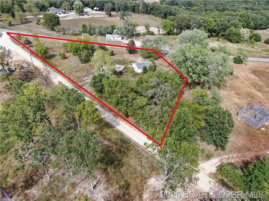 Enjoy the peaceful setting and convenience of a lot that’s ready for your vision! Discover the perfect opportunity to build your dream home on this spacious 1-acre lot. The property already includes an existing basement foundation, a spacious 2-car garage, private well, electric hookup, and a lagoon—saving you time and money as you plan your build. So much of the essential groundwork has already been completed. Located just 15 minutes from Osage Beach, this would be a great property for someone looking to move to the country while still having a short commute.
Note: This listing is for the lot and existing improvements only. The house shown in the photo is a virtually generated rendering to illustrate potential and is not included in the purchase price.