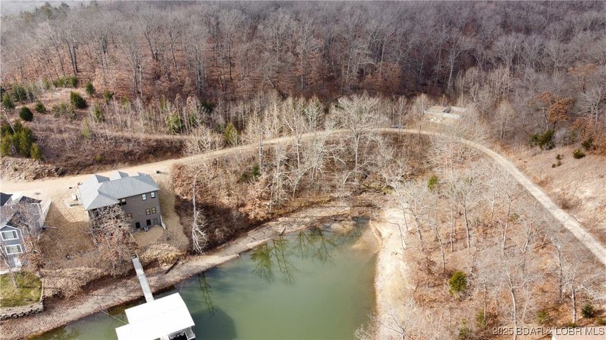 215 +/- feet of Lake of the Ozarks waterfront located in Rainey Creek Cove. Offering stunning water views and endless potential. Theseproperties feature access to community water and sewer, making them ideal for a smooth and efficient build process. Whether you’redreaming of a private custom home or a vacation retreat, these lots provide the flexibility to bring your vision to life. Located in a quietlakefront neighborhood, by water you’ll find yourself tucked away off Mile Marker 60 — offering peaceful surroundings with easy accessto open water.