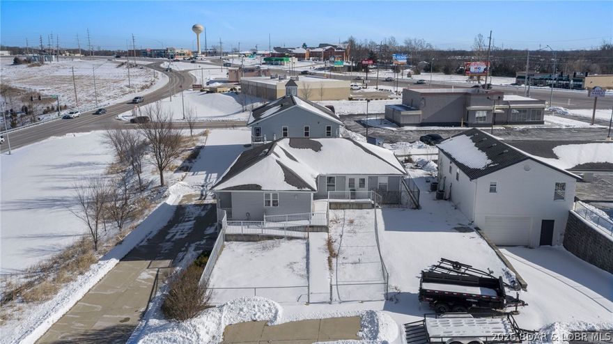 This is a POWERHOUSE listing!! Exceptional high-traffic commercial investment opportunity at one of the most prominent intersections at Lake of the Ozarks. The prime corner location delivers maximum visibility, consistent vehicle count exposure, and strategic positioning in the heart of a thriving commercial corridor. Featuring TWO commercial buildings totaling over 4,200 square feet, this property offers flexibility for multi-tenant income, owner-user occupancy or redevelopment potential. The layout supports a variety of commercial uses including retail, professional office, or service-based operations. With strong frontage, superior signage opportunities, and immediate access to surrounding retail and attractions, this is a rare chance to secure a cornerstone property in a high demand market. Opportunities in locations like this are limited-especially at intersections that anchor long-term commercial growth!!!