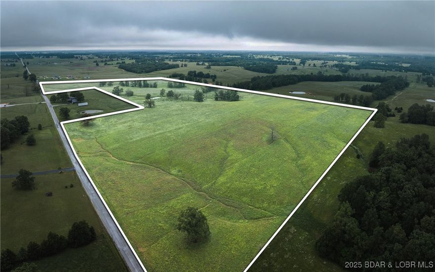 58+/- Acres – Dual Road Frontage, Pond, Prime Location
This 58+/- acre tract in Barry County is a rare opportunity with endless potential. Featuring a beautiful mix of gently rolling pasture and picturesque scenery, the land includes a peaceful pond and blacktop road frontage on two sides for outstanding access and development flexibility. Ideal for building, farming, or future subdivision, the land is open and usable with excellent grass and minimal waste. No zoning or restrictions means you can bring your vision to life—whether it’s a private homestead, mini-farm, or investment project. Located in a desirable area just minutes south of Walmart and close to Springfield, Branson, and Aurora. Utilities nearby. Don’t miss this chance to own usable, high-quality land in a top-tier location!