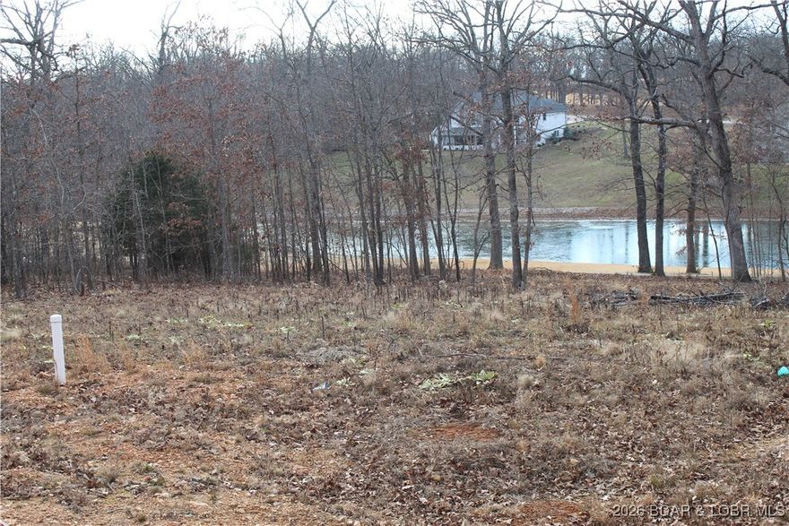Discover this ready-to-build lot overlooking a peaceful pond near the 2nd hole of the Indian Rock Estates golf course. This nearly ½-acre parcel has been selectively cleared to create a generous building envelope while maintaining privacy, thanks to a natural windbreak and screening on the property lines.
Save both time and significant expense—essential infrastructure is already in place, including the feed for the shared well and a grinder pump tank for city sewer connection, making this property truly build-ready. The lot’s layout easily accommodates a variety of home designs, from slab-on-grade to crawlspace or walkout construction.
Power is conveniently located next door, requiring only a single pole to be placed. The property has recently been professionally surveyed, with clearly marked corners, and is subject to City of Laurie housing specifications.

This is a shovel-ready opportunity to build your dream home in a tranquil golf course setting with utilities already in place, bring your plans and start building asap!