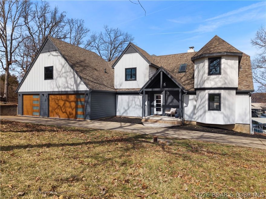 A remodeled masterpiece! This extraordinary waterfront home has been taken down to the studs and  completely reimagined with new LP smart siding, windows/doors, HVAC units, flooring, and drywall. Finished with custom steel railings, built in bunk bunks, designer lighting, and spa like bathrooms. On the main and lower levels, two sets of ~12 ft custom slider doors showcase the impeccable main channel views. Situated directly across from Four Seasons for a front row seat to the lakes best fireworks display. Enjoy the gentle sloping double lot with your own private beach and room for a pool. Furniture included and NO HOA (short term rentals are allowed). To complete the package, a three-car garage and expansive circle driveway with ample parking. This is luxury living at its finest - built to impress!