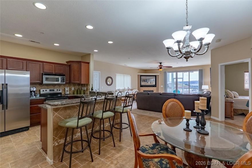 Wow—this condo is truly exceptional! Offering an impressive 3,000 sq. ft. of living space (plus a massive screened-in deck), this residence provides room for everyone with no exterior maintenance and a 14x40 boat slip right outside your unit. It feels more like a home. Direct elevator access with no stairs, opening into a spacious great room featuring a corner fireplace, beautiful lake views, and walk-out access to an oversized tiled screened-in porch. Green space right outside your door—perfect for pets and lawn games. Easy walk to the community pool and fitness center. Open kitchen has upgraded cabinetry and huge walk-in pantry with full bar and extra refrigerator. Two separate living areas could allow for a possible 5th bedroom. Three bedrooms are lakeside en-suites, including a primary suite with two walk-in closets. Sold turn-key and includes storage and full-size washer/dryer. A 14x40 cruiser slip is included. Three covered PWC slips and garage available for additional cost. Uncovered PWC slips also available. Numerous upgrades throughout. Seller open to trades. Prime location by land and water—minutes to restaurants and amenities. Ideal for full-time or part-time living.