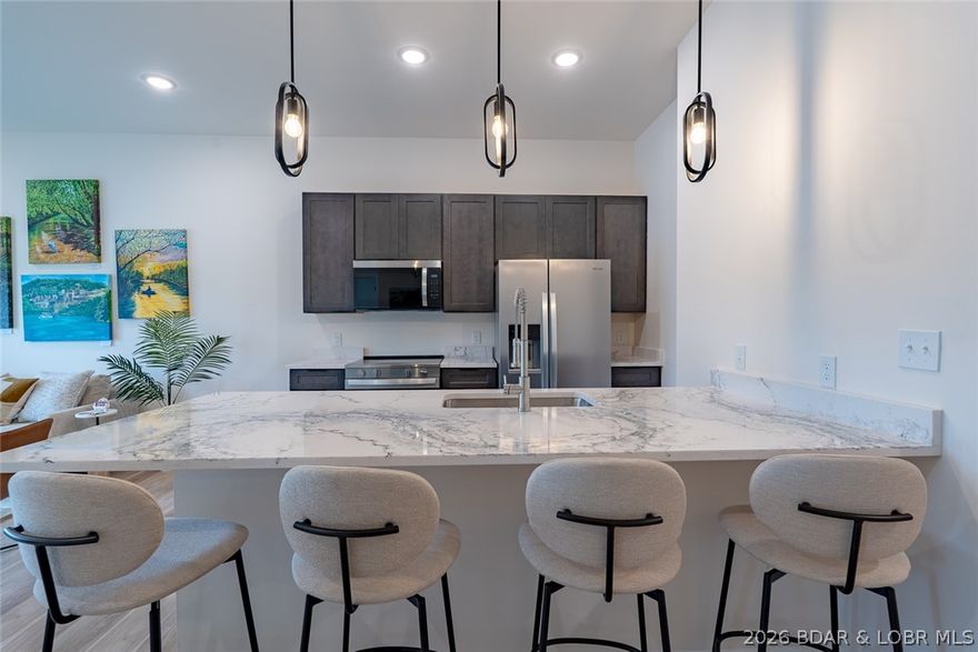Experience refined lakefront living in this brand-new unit at Ember Ridge, constructed with steel-frame construction for lasting quality and durability. This 3-bedroom, 3-bath new-construction condo offers an open floor plan designed for comfortable everyday living and effortless entertaining.  Enjoy beautiful lake views and true lakefront positioning.  Convenient elevator access. Ideal for full-time living, a low-maintenance lake retreat, or a great investment.  Close to many great lakefront restaurants, a great spot to host family and friends or just relax by the water!  Ember Ridge offers a polished and practical way to enjoy life at the lake.  Photos are of Model unit #205
