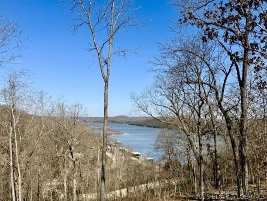 A beautiful 1-acre lake view property made up of 3 combined lots at the Lake of the Ozarks! This unique parcel offers flexibility for building your dream home, creating a vacation getaway, or setting up the ultimate RV retreat. The land has been partially cleared featuring 2 separate driveway entrances with white gravel parking areas, making it ideal for multiple campers, RVs, or future building plans. Electric is already in place with two 30-amp hookups, giving you the convenience to start enjoying the property right away. Enjoy lake season, summer weekends, and relaxing evenings with beautiful lake views located near the 65 MM on the Osage Arm close to lake fun and local favorites including Bottoms Up, Patriot Point, and The Wet Spot. Boating access is nearby at the Brown Bend Access Ramp and the POA community dock offers 4 boat slips and 2 PWC slips. Whether you envision building a full-time residence, creating a weekend lake escape, or establishing a short-term rental investment, this property offers incredible versatility!