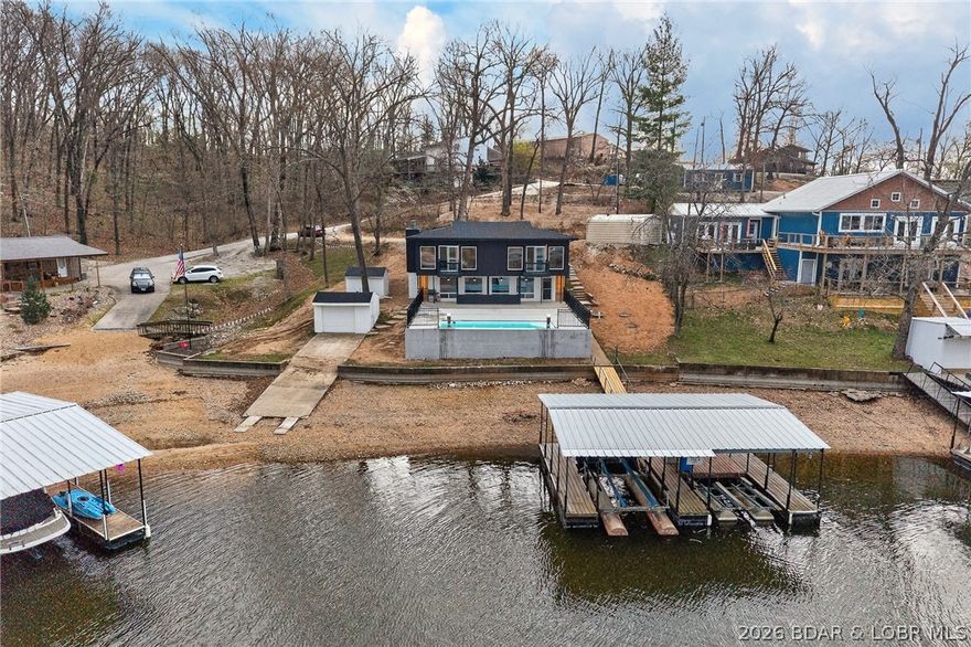 STUNNING, UPDATED LAKEFRONT OASIS IN AN UNBEATABLE LOCATION! 4-bedroom, 3-bath retreat is perfectly positioned in one of the most coveted coves at Lake of the Ozarks—just around the corner from the ever-popular Franky & Louie’s Beachfront Bar & Grill. Set on a gentle, flat lot with breathtaking panoramic water views and effortless lake access that truly captures the best of lake living. Start your mornings on the expansive deck overlooking the water, spend your days boating, swimming or relaxing in the calm, protected cove and unwind in the evenings with unforgettable sunset views. Enjoy the ultimate outdoor lifestyle with an in-ground pool and private dock—perfect for soaking up the sun, entertaining guests or heading out on the water at a moment’s notice. With ample parking and a highly desirable layout, this property is ideal as a full-time residence, weekend getaway or income-producing vacation rental. The combination of location, amenities, and setting makes this a rare opportunity to own a true lakefront gem in one of the most sought-after areas. Lakefront properties like this don’t come along often—start living the lake life you’ve been dreaming of! WELCOME HOME!