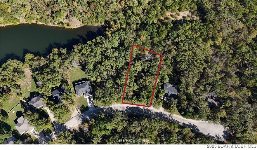 Opportunities to secure a buildable residential lot within the prestigious Four Seasons community do not come along often—especially one of this size, setting, and price point. This .50-acre parcel offers the ideal foundation for your future full-time residence, vacation retreat, or long-term hold in one of the most desirable and stable communities at Lake of the Ozarks. Perfectly positioned just a short walk from an interior lake, this lot provides a quiet, natural setting while keeping you moments from everything Four Seasons has to offer. Four Seasons is widely regarded as one of the most amenity-rich and well-maintained associations at the Lake. Ownership here grants access to multiple swimming pools, fishing lakes and stocked ponds, tennis and pickleball courts, walking paths, a dog park, community boat ramps and docks, playgrounds, and well-kept common areas throughout. The community is known for its long-standing commitment to quality, consistency, and curb appeal—factors that protect long-term value and make this a secure place to build or invest.