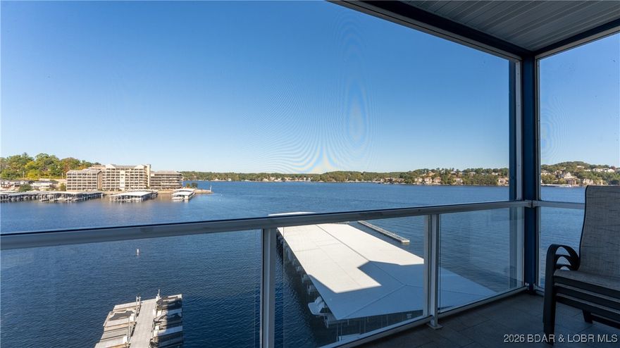 Wow!  What a View!  Ride the elevator to a SUPER CLEAN lakefront condo, suited perfectly to accommodate your fabulous lake lifestyle.  A very well maintained 3-bedroom, 2-bathroom residence at highly desirable Monarch Cove that delivers on every level. This spacious kitchen has a huge pantry and breakfast bar seating. Wake up on LAKE time in your primary suite where you'll enjoy dual sinks and a jetted tub in the shower.  Welcome your guests with two generously sized bedrooms and a bathroom with a step in shower.  There's plenty of room for your friends and family to enjoy our beautiful lake with you.  Step outside and take in the view from your fully screened in deck; perfect for morning coffee or your favorite evening beverage. There's always something to do at the LAKE, whether its golf, shopping, fine dining or one of our many fun local events, you'll be close to all the action at this ideal Horseshoe Bend location.  Round it out with a 12x36 slip and one PWC space with a lift. Take ownership of your slice of paradise, CALL YOUR REAL ESTATE PROFESSIONAL TODAY!