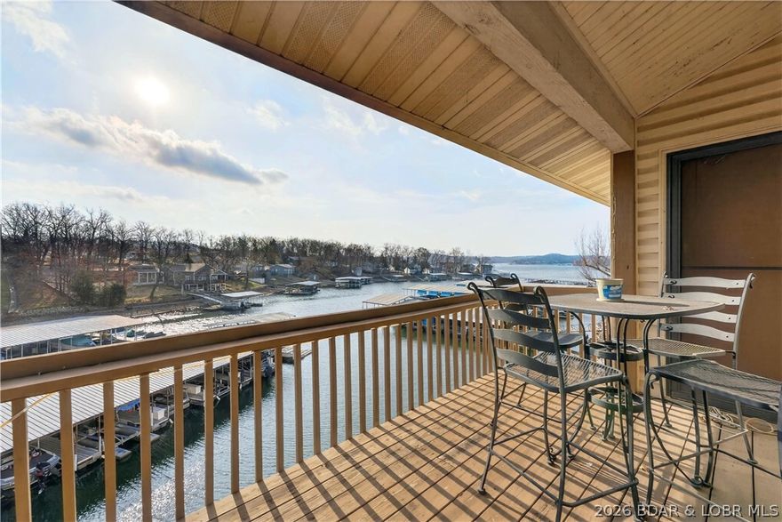 At Wrenwood Condominiums, tucked along the quieter end of Horseshoe Bend, this furnished 2-bedroom, 2-bath top-floor end unit offers a relaxing Lake Ozark retreat with investment potential. Vaulted ceilings and an open living, dining, and kitchen area create an airy, welcoming feel, while the covered deck is the perfect place to unwind with peaceful cove protection and main channel views. Rentals are allowed, including nightly, weekly, monthly, and long-term options. Owners also enjoy community amenities like a pool, tennis courts, playground, and a covered dock with an included 10x24 slip and 8,000 lb lift.