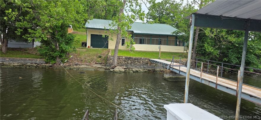 Well built custom home on the 4 mile marker of the clear waters of the Gravois Arm in Millcreek Cove.   Large country kitchen, Spacious master bedroom with walk in closet, oversized 2nd bathroom with jetted tub, screened in porch.   Great views of Millcreek with DEEP water under your 2 well dock.  480 sq ft bonus area that could be made into extra bedrooms, extra living area or just keep it as a shop.  Detached storage shed for lawn equipment, tools, or  water toys.  Close to some of the fun Restaurants on the lake, including Lake Burger, Coconuts, Hillbilly Yacht Club, Maggies on the Water and Jolly Rogers.  Dock just brought up to Ameren Electric Code 2026.