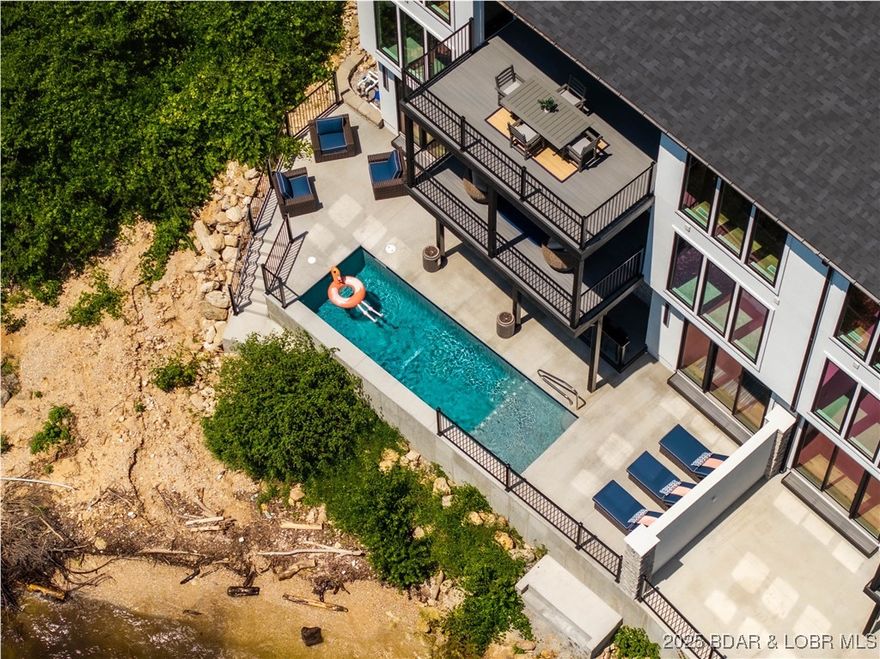 The Enclave at 14 Mile is an Elite Collection of 10 Exceptionally Designed Homes. Nestled along the shoreline, a Premiere Horseshoe Bend Parkway gated entry leads into your attached two car garage, offering security and privacy. You’ll step into warmth, texture and superior artistry with a myriad of indoor and outdoor luxury amenities and products including your private pool right at the lake’s edge. 4,030SF, 4BR | 4FullBT | 2Half BTH, Main level great room with kitchen, primary suite, laundry & powder room. Midlevel family room, three bedrooms & three full baths. Lower level has a pool bar/kitchen w/roll up windows overlooking the pool patio plus a game room & guest bath. Cruiser and powerboat slips available. Homes are built villa style w/adjoining concrete block firewall for safety & soundproofing. Be sure to watch the video of the model!