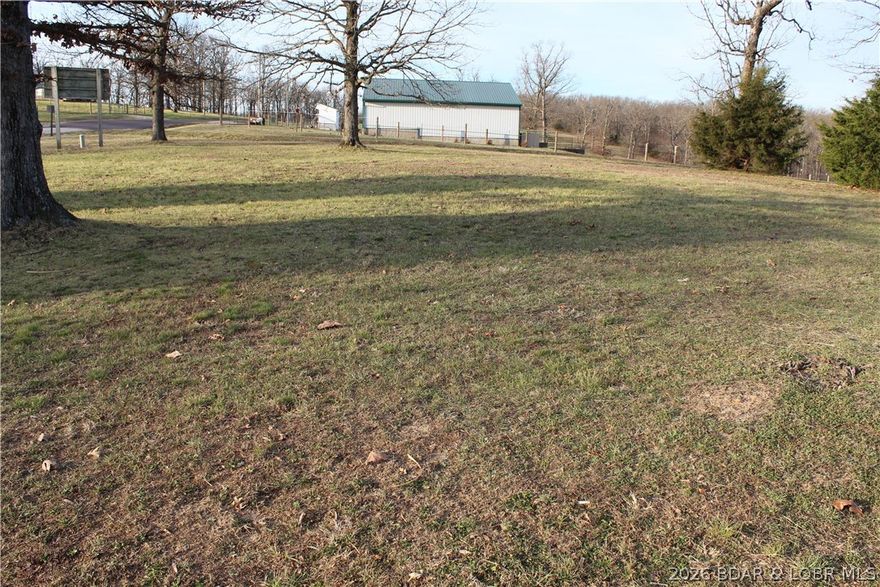 Enjoy the views from this easy-to-access Lake View lot at the peak of the Johnson Bay Subdivision. You'll appreciate the already installed Community water and sewer at the rear of the property enabling unlimited footprint options for your Lake of the Ozarks dream home!