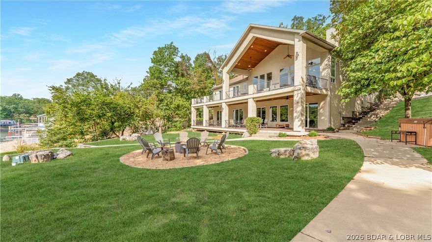 Exceptional turnkey waterfront investment opportunity at Lake of the Ozarks featuring 2 homes on 1 premier lakefront property at the 24MM. This proven high-demand vacation rental is being offered fully furnished and is designed to maximize both guest experience and income potential. The main home offers 7 private ensuite bedrooms, vaulted ceilings, spacious open-concept living, large kitchen, game room, full bar, and multiple lakeside decks. The guest home adds 2 additional ensuite bedrooms, full kitchen, living space, and upper/lower lakeview decks—creating ideal flexibility for larger groups and premium rental performance. Situated on 1.17 acres with 171' of waterfront in a quiet cove just off the main channel, the outdoor setup is a major draw with a private dock featuring 2 boat slips, PWC lift, swim dock, beach area, hot tub, fire pit, and large yard. Recent updates include new roof and HVAC. Rarely does a property combine size, sleeping capacity, amenities, location, and proven rental appeal this well. A standout opportunity for investors seeking a high-capacity, income-producing lake asset.