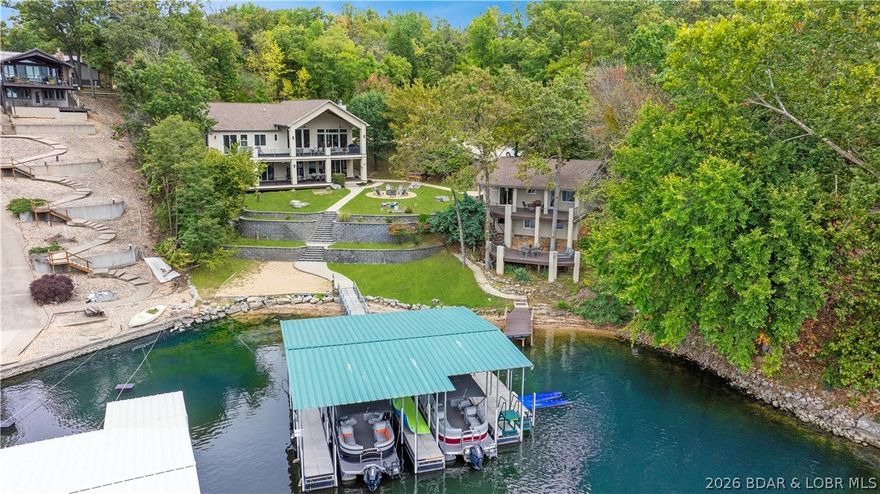 Exceptional turnkey waterfront investment opportunity at Lake of the Ozarks featuring 2 homes on 1 premier lakefront property at the 24MM. This proven high-demand vacation rental is being offered fully furnished and is designed to maximize both guest experience and income potential. The main home offers 7 private ensuite bedrooms, vaulted ceilings, spacious open-concept living, large kitchen, game room, full bar, and multiple lakeside decks. The guest home adds 2 additional ensuite bedrooms, full kitchen, living space, and upper/lower lakeview decks—creating ideal flexibility for larger groups and premium rental performance. Situated on 1.17 acres with 171' of waterfront in a quiet cove just off the main channel, the outdoor setup is a major draw with a private dock featuring 2 boat slips, PWC lift, swim dock, beach area, hot tub, fire pit, and large yard. Recent updates include new roof and HVAC. Rarely does a property combine size, sleeping capacity, amenities, location, and proven rental appeal this well. A standout opportunity for investors seeking a high-capacity, income-producing lake asset.