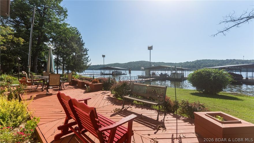 Gorgeous flat lakefront property with no HOA!  This spacious lakefront home offers effortless access to the dock from the patio. The concrete driveway provides ample parking, along with a detached garage, a 15x15 golf cart shed, and a flat entry to your new lake oasis. Ideal for enjoying sunrises and sunsets, this property features a 3-bedroom, 2-full bath home with ample entertaining spaces, including a main level family room, a 10x32 open sunroom, and downstairs main living areas with a large living room. The property includes a lawn, firepit area, patio, and two well-maintained docks. Additional storage is provided by another shed for water toys. The previous garden area could easily be revived for your enjoyment. Walls of windows on both levels allow for year-round lake views. Newer features include a heat pump, septic tank, concrete driveway, electric fireplace, and a new metal roof to be installed in 2025. The heated 26x40 three-car garage includes a workshop area and storage. The seller has enjoyed the neighborhood, the location and the house for many years on a full time basis, and are pleased to pass this along to the next owner with pride!