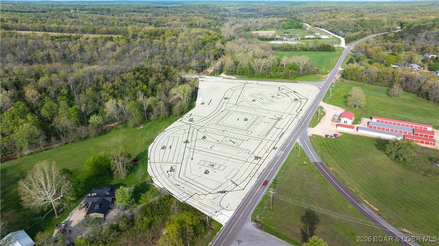 This incredible corner commercial lot is located just 10 minutes from Osage Beach down Hwy 42 in Brumley and sits just down the street from the new Dollar General, placing it directly in the path of continued growth as lake-area development expands toward Brumley. The property is ideally suited for development and includes a proposed site plan for “Brumley Junction,” featuring a service station, large retail store, restaurant, car wash, storage units, and an additional tract designated for future expansion. Encompassing more than six acres, the property offers over 1,000 feet of hwy frontage along both Hwy 42 and Hwy C, providing exceptional visibility and access from two major hwy systems. The land is extremely level, pristine, and has been properly filled and allowed to settle to achieve an ideal grade for development. As a highly visible corner lot, it offers unmatched exposure and usability, making it difficult to find a comparable parcel of this size and quality. Easy to locate and impossible to miss, this property presents a prime opportunity for a wide range of uses, especially with no zoning restrictions in Miller County, allowing maximum flexibility for future development.