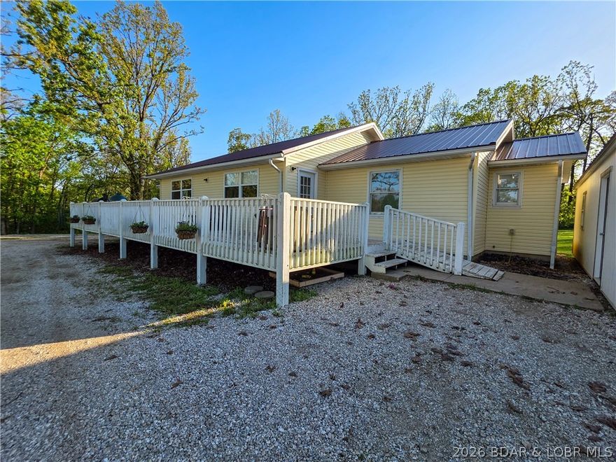 Enjoy the perfect blend of country living and convenience with this charming ranch home nestled on 3 scenic acres. Tucked just off the short gravel road, this property offers privacy, peaceful surroundings, and beautiful views.  The large yard will be great if you want a garden or a fantastic area for your kids to thrive in the outdoors. The inviting front deck is the perfect spot to relax with your morning coffee or unwind in the evening while taking in the countryside. Inside, you’ll love the open-concept layout that creates a seamless flow between the living, dining, and kitchen areas—ideal for everyday living and entertaining. The property also includes an additional storage building, providing plenty of space for tools, hobbies, or extra storage needs. Whether you work in Jeff, Eldon or Versailles, this location has you covered. You’ll enjoy the best of both worlds—rural tranquility with easy access to amenities. This property offers space, comfort, and a true country feel.