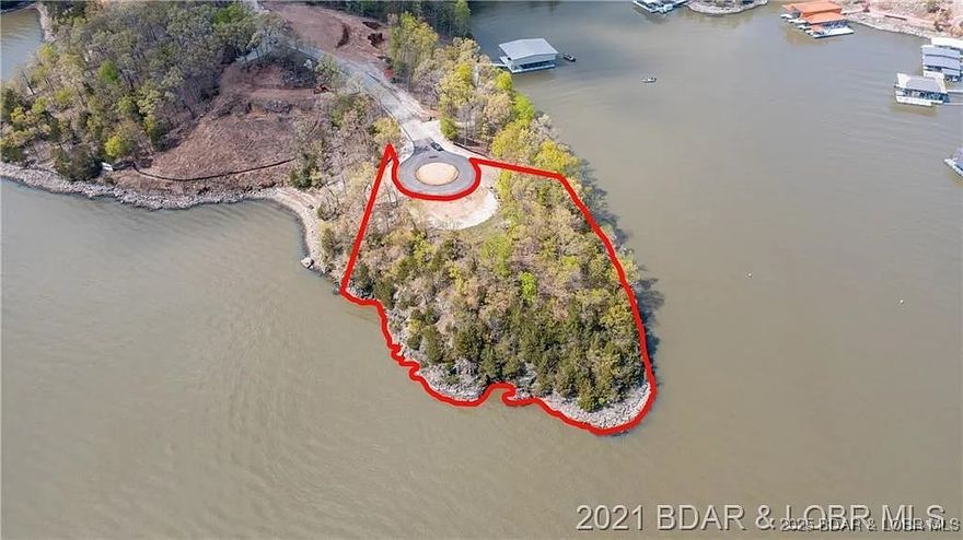 An extraordinary opportunity to own one of the most exclusive lakefront lots ever offered at Lake of the Ozarks. Located at the end of a cul-de-sac in the gated Villages at Shawnee Bend, this gentle point lot features approximately 671 feet of shoreline with both main channel and cove-protected frontage—a truly rare combination.
 
Enjoy sweeping 270-degree views that extend for miles, along with deep water and dramatic rock bluff formations that create stunning natural character. The quiet cove side offers ideal conditions for your private, estate-sized dock, while the main channel side delivers breathtaking vistas day and night.
 
Situated at the 22 Mile Marker, this lot is adjacent to some of the Lake’s most prestigious homes. With community water and central sewer hookups available, it’s ready for you to create a landmark lakefront estate designed to match your vision.
 
A property of this caliber—combining gentle topography, expansive shoreline, and unmatched views—rarely becomes available. Discover the potential of 504 Forest Trace and experience lakefront living without compromise.