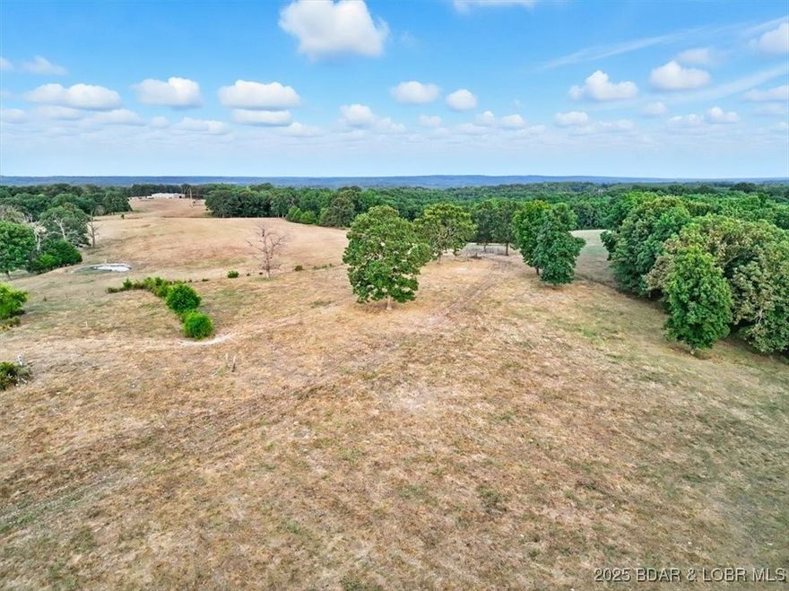 This rare 80+/- acre property offers the perfect blend of convenience and country living. 6 stock ponds plus a large catfish pond, 75% open Hay fields, fenced and crossed fenced, an old barn is included, Abundant wildlife with great stand locations throughout property. Located just outside city limits, yet close to town, opportunities like this are seldom available.  This is the first time on the market since the 1930s.  The land is fully equipped with excellent fencing and cross-fencing, multiple stocked ponds, and a couple of seasonal creeks, making it ideal for cattle, hay production, or recreation.  With a balance of open pasture and wooded acreage, the property provides outstanding hunting opportunities and is teeming with wildlife.  Whether you’re seeking productive farmland, recreational retreat, or a private homestead, this property checks all the boxes. All this with easy access, located 7 miles south of Camdenton.