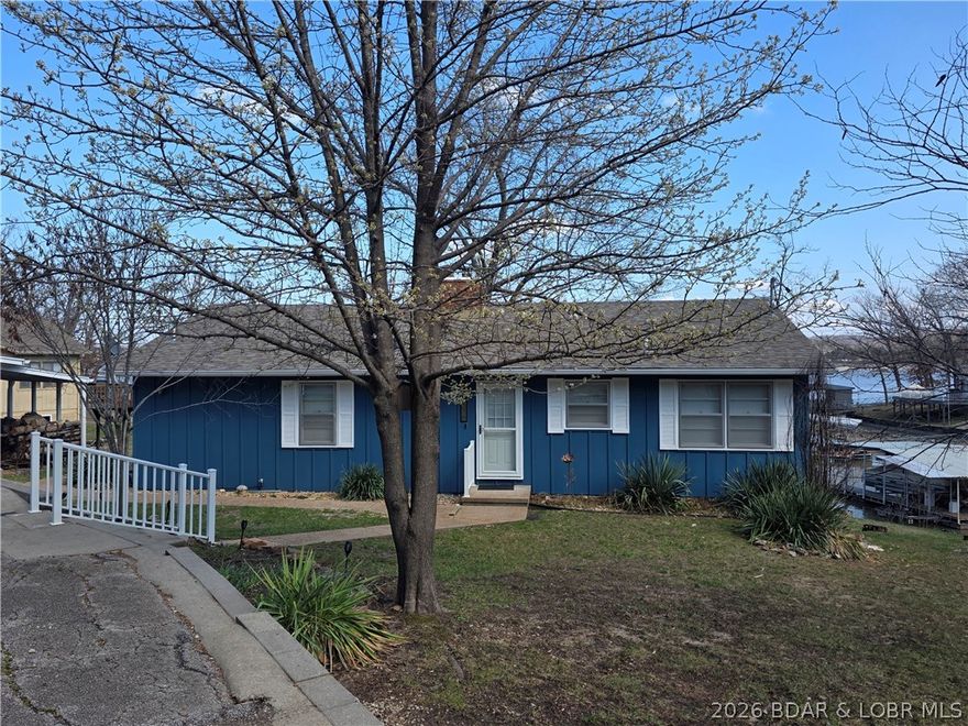 Open Thursday 11 to 2pm . Come check out this Beauty and join us for lunch! Beautiful lakefront, level Property on the quiet side of the lake. 2 Levels of family living or combine or separate for STR property. Each has Kitchen, Full bath, Family Room & 2 large bedrooms, freshly painted and very nicely furnished. New Electric Fireplace (2026), Hardwood floors (mail level) & Luxury Vinyl (2025) Lower level. New Sliding glass doors Lakeside, Family Rm & Master Bedroom (2025) 3 out buildings, 2 car garage, 1 car garage and 1 car Shop all have overhead doors. Rhino Shield/Ceramic Coating Exterior (2025) on all buildings, No exterior maintenance needed for 20-25 years. 12 x 28 Boat Dock with 6000-8000lb hoist and Wet Steps included.