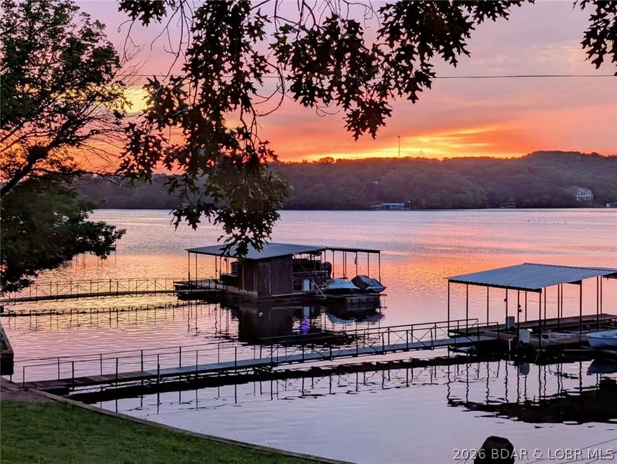 Open Thursday 11 to 2pm . Come check out this Beauty and join us for lunch! Beautiful lakefront, level Property on the quiet side of the lake. 2 Levels of family living or combine or separate for STR property. Each has Kitchen, Full bath, Family Room & 2 large bedrooms, freshly painted and very nicely furnished. New Electric Fireplace (2026), Hardwood floors (mail level) & Luxury Vinyl (2025) Lower level. New Sliding glass doors Lakeside, Family Rm & Master Bedroom (2025) 3 out buildings, 2 car garage, 1 car garage and 1 car Shop all have overhead doors. Rhino Shield/Ceramic Coating Exterior (2025) on all buildings, No exterior maintenance needed for 20-25 years. 12 x 28 Boat Dock with 6000-8000lb hoist and Wet Steps included.