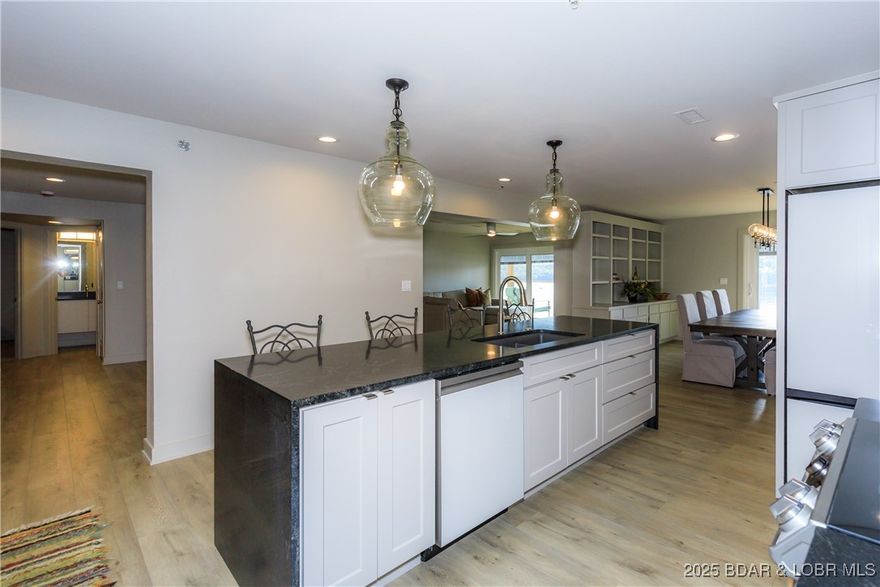 This stunning first-floor 6-bedroom, 4-bath condo has been fully remodeled from top to bottom! Updates include new cabinets, doors, LVP flooring, two HVAC units, two water heaters, new appliances, and all-new furniture and bedding. The modern kitchen features a granite waterfall island, two refrigerators, and a pantry. Three bathrooms feature walk-in showers and one has a tub/shower combo, all with floating vanities. Enjoy the comfort and privacy of two master suites with access to the expansive deck! All on one level, this condo is incredibly spacious, offering plenty of room to relax or entertain. Stairs lead down to your 12x30 boat slip, pet-friendly green spaces, and expansive Lake of the Ozarks views. Located on a quieter arm of the lake—perfect for fishing, boating, kayaking, and coving out. Community amenities include a pool, clubhouse with workout room and kitchen, firepit area, and playground. Accessed through Lake of the Ozarks State Park, this condo offers the perfect blend of privacy, luxury, and lakefront fun! This unit is a great investment opportunity and/or the perfect family getaway. Dreams to Reality! Call Today!