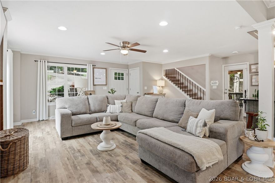 Peaceful serenity, privacy & seasonal lake views in the heart of Four Seasons community! Beautifully remodeled, 3 bedroom, 3 bathroom home on amazing double wooded lot! 2904 sqf of awesome living space. The main level features LVP flooring, remodeled Kitchen w/granite countertops, stainless appliances, custom cabinets & island, a large living area w/electric fireplace, full bath, 2 bedrooms & laundry room. The upper level is dedicated as the Primary Suite w/walk in closet, walk in shower & double vanity. The entertainers lower level has a wet bar, full bath, storage room & access to the heated/cooled garage. You will also love the outdoor areas...wrap around deck, side screened deck w/open area for grilling right off the kitchen, 0.73ac of land to enjoy & lots of extra parking space. Seller has approved building plans for a detached garage should new owner desire more garage space. Access to Four Seasons amenities are a short easy walk behind the home....community pool, community day dock, pickleball , playground etc...fun things for everyone and close to home! Incredible opportunity to own a fantastic home on a double wooded lot in a great location...Such a great property!!!