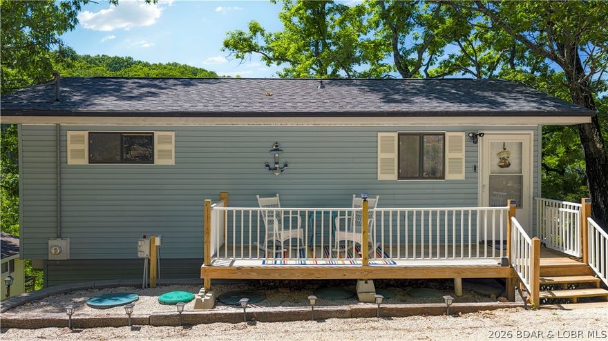 Tucked along a quiet cove at the 3 MM, 131 Walnut Drive is the kind of Lake Ozark retreat that feels easy from the moment you arrive. Fully remodeled and furnished, this lakefront getaway offers updated finishes, a newer roof, newer septic, newer front porch, newer deck, and newer steps leading down to the dock. Spend mornings with coffee on the deck, afternoons on the water from your covered 1-well dock with 10x26 slip, and evenings relaxing in a move-in-ready space designed for lake life. With vacation rentals allowed, 50 feet of waterfront, a surveyed lot, and a walkout lower level, this property offers both personal enjoyment and income potential. The 3rd bedroom is non-conforming with no closet.