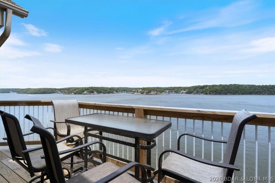 This beautifully updated condo sits high above the lake with soaring ceilings and an entire wall of windows that frame miles of open water. Morning coffee on the deck? Sunset cocktails? It all feels like you’re on vacation—because here, you kind of are. Located in the heart of Osage Beach at the 21MM, you’re minutes from the lake’s best restaurants, shopping, and entertainment. Your boat stays protected in a calm cove with a breakwater, so you can watch the go-fast boats cruise by without the waves rocking yours. Looking for an investment property? This unit is completely turn-key—furnished, styled, and fully stocked giving you a seamless, income-producing start from day one. The Ledges offers two pools, a sandy beach, and a playground — making it a favorite for families and vacationers alike. And the spacious loft functions as a generous third bedroom, giving you plenty of room for guests.