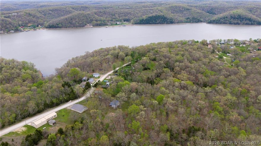 Attention Weekenders and Investors!! We have a perfect opportunity for you to own your slice of heaven here at our Beautiful Lake of the Ozarks. A stone throws distance from the water yet plenty of privacy and room to grow! This property includes a very cute partially remodeled cabin with covered front deck to enjoy the wonderful summer evenings and and listen to the boats go by, it also includes over 4 acres to enjoy hiking, riding atv/utvs or just for future expansion of your dream property. Call today and schedule your showing! THIS ONE IS PRICED TO SELL!