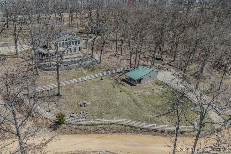 Hobby Farm, Animal Lovers & Lake Enthusiasts—28 Delancey St is for YOU! This 4 ac (+/-) property features a gentle lakefront lot, horse stable w/ 1/2 ac field, & large shop for equestrian or hobby farm storage. The lower barn offers 2 stalls, concrete floors, stable doors, shaded overhang, & a grazing area, all enclosed with 1,000’+ of white vinyl fencing. The chicken condo has inside flock access, storage, & egg collection. Raised garden beds & a nearby greenhouse make growing your own produce easy. Inside, the kitchen boasts granite countertops & stainless appliances; the main floor primary suite offers a walk-in closet & spa-like bath. The living room’s vaulted pine ceilings & wall of windows overlook lakefront grounds. The lower-level study & family room provide work-from-home or leisure space, while the guest suite offers privacy with an en suite bath. Enjoy a beach & dock in a protected cove for swimming, fishing, & fun. A 1,548 sf heated/cooled garage offers a diverse use of space for vehicles, entertaining, & personal interests. 28 Delancey St is a ONE of a KIND property...More than a home—it is a lifestyle of comfort, utility & lakefront bliss.