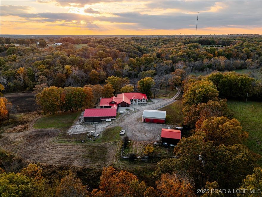 Discover an exceptional 40-acre property that perfectly balances open and wooded landscapes, offering endless possibilities for country living. With approximately 15 acres of tillable ground, this land is ideal for farming, livestock, recreation, or creating your own private retreat. Fully fenced w/ cross fencing in place & featuring beautiful year-round creeks, it provides both functionality & natural charm. At the heart of the property stands a nearly 10,000 sq. ft. self-sustained home designed for comfort, independence, and large-scale living. With 8 spacious bedrooms & 8 bathrooms, there’s room for family, guests, or a multi-generational lifestyle. A robust 36,000-watt whole-home generator ensures peace of mind & reliable off-grid capability. Supporting structures include a 40x60 shop/trophy room, a barn, & a machine shed—offering exceptional versatility for equipment storage, hobbies, or business use. Whether you’re a rancher, hunter, investor, or simply seeking a self-reliant lifestyle surrounded by nature, this property delivers a rare combination of beauty, functionality, & opportunity. This property is a hunter's paradise w/ abundant wildlife and Multiple hunting Blinds.