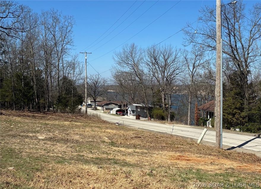 Discover the perfect spot to build your Lake of the Ozarks dream. This larger-than-average Osage Beach parcel offers a seasonal lake view, lake easement, gentle terrain, and the kind of space and flexibility that’s hard to find in town. Tucked in a quiet setting yet minutes from shopping, dining, medical services, and the exciting new Bass Pro development, it blends convenience with a peaceful, retreat-like feel. Whether you’re planning a full-time residence, a seasonal getaway, or an investment property designed for long-term value, this lot gives you room to design exactly what you want—outdoor living, extra parking, a shop, or future expansion. Public utilities are available that adds to the ease of building. A rare opportunity in a fast-growing corridor of Osage Beach—secure your piece of the lake lifestyle and create a property that fits your vision.