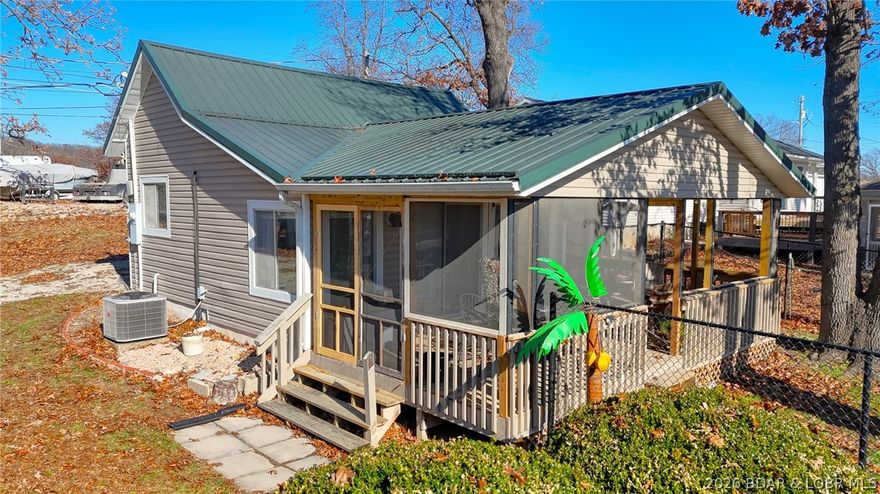 Charming lake bungalow with big possibilities! Whether you’re searching for a weekend escape or a full-time lake home, this one-bedroom, one-bath property delivers comfort, convenience, and lifestyle. Enjoy relaxing on the covered porch while taking in peaceful lake views. The large lot offers excellent potential for future expansion, while the 14x30 garage/storage building- featuring a 9’9” wide overhead door and multiple outlets- provides ideal space for a workshop, hobbies, or storing all your lake gear. Deeded lake access directly across the street makes swimming, playing, and enjoying the water effortless. Low-maintenance vinyl siding and a metal roof simplify ownership, and the property is equipped with a shared sand water filtration system in the front yard along with a reverse osmosis drinking water system under the kitchen sink. Located near two marinas with slip availability and just minutes from Laurie for shopping, dining, and everyday conveniences, this home proves that small spaces can deliver a BIG lake lifestyle.