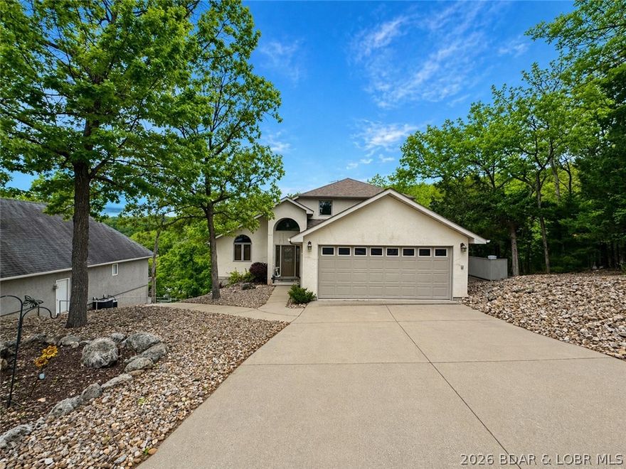 Tucked into a peaceful DEEP-WATER COVE in Four Seasons, this inviting lakefront home offers 75 feet of shoreline and the kind of quiet setting that makes it easy to unwind. With nearly year-round boating access and a private golf cart path to the dock, lake days are always within reach. Inside, you’ll find 5 bedrooms, 3 full baths, and 2 half baths, with a comfortable open layout that brings everyone together. Vaulted ceilings and large windows fill the main living space with natural light, while the kitchen flows easily into the dining and living areas—perfect for gathering with family and friends. The main-level primary suite is a relaxing retreat with plenty of space, dual closets, and a spa-like bath. Guests will feel right at home with private bedroom spaces on both upper and lower levels, and a cozy lower-level wet bar for easy entertaining.
After a day on the water, come home to soak in the hot tub or unwind in the sauna. The dock offers a 12x32 slip (currently 12x30) with room to expand, and the property includes great parking, a 2-car garage, and even a second lot if you want to build something extra! Will come mostly furnished.