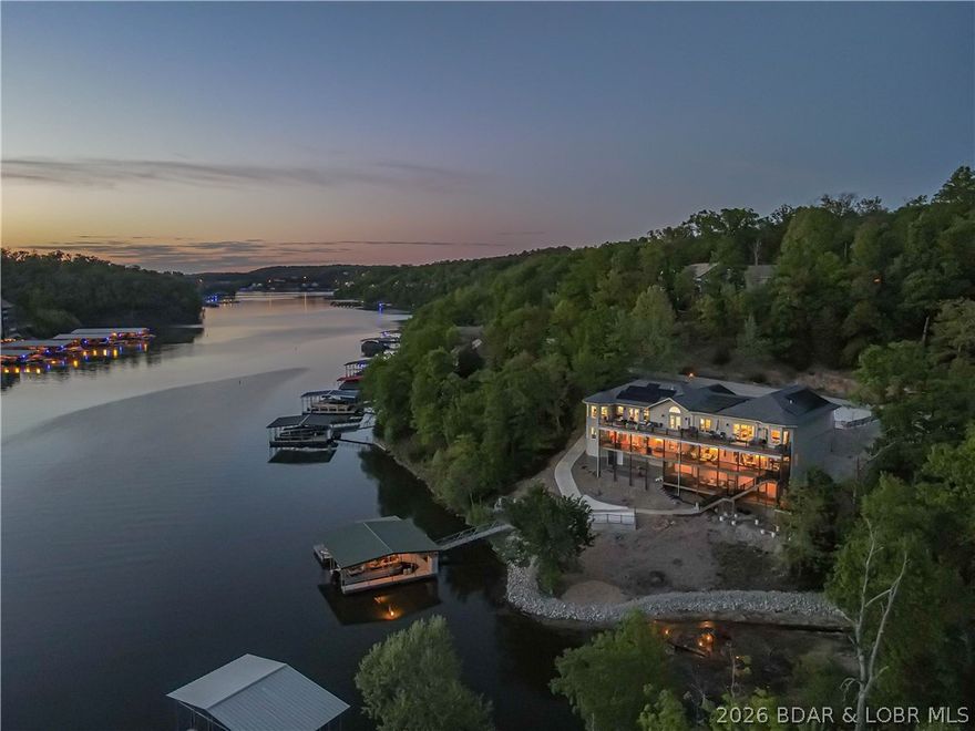 Move-In Ready! Solar Efficient Lake Home with energy bill averaging $80 per month! You don't want to miss this exclusive lakefront home with dock in Linn Creek Cove, MM31, Lake of the Ozarks. This custom furnished home has a 2023 new build with a 2010 fully renovated wing located in the established quiet Cross Creek neighborhood, sitting on 1.74 acres, has a fabulous lakefront view & 621 feet of lake frontage. The home boasts 5670 sq. ft. of interior living space,4 car garage bays with oversized garage area,& add'l parking on the wide, gentle sloped concrete driveway.The main interior floor offers open floor living, vaulted ceiling,stacked stone gas fireplace, chef's kitchen & dining room with hardwood floors. It features a great room, 2 master ensuites, 2 add'l beds, add'l 1.5 baths, & laundry. Lower level boasts family rm, entertainment rm, 3 beds, exercise/bonus rm, office/bedrm, 3 baths, bar room, & dining area. Enjoy your hot tub, wet bar, sitting area, game area, & lakeside firepit. A concrete dock with 2 boat slips, double PWC slip, swim platform, dock bar, & storage area completes the package. A perfect home to enjoy year-round or seasonal with your family and friends!