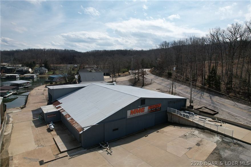 Waterfront business opportunity on Lake of the Ozarks. If you are looking for property to build or expand your business, this could be it. Marine fiberglass repair & Auto body repair shop with your own launch ramp. This building is approximately 10,000 sq ft under roof with varying states of improvements. Currently has side draft paint booth and paint mixing room. Also plenty of room for storage in different areas of building. Separate building has office and small studio apt possibility.