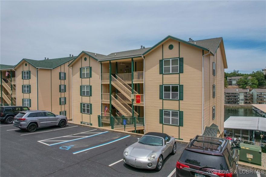 Ready for spring & summer fun—this lakefront WALK-IN condo is move-in ready! Beautifully maintained and furnished 3-bedroom, 2-bath condo. This condo features an open, inviting floorplan, stainless steel appliances, 2 years new HVAC system, newer carpet & a 12x30 boat slip close-by! The living room showcases a tiled fireplace, a wall of windows w/ stunning lake views, and sliding glass doors that lead to an expansive screened-in lakeside deck. This spacious deck offers an additional storage closet & plenty of room to relax or entertain while enjoying the water views. The primary suite also has direct access to the deck, creating the perfect retreat. 2 guest bedrooms and a full bath are conveniently located off the entry hallway, giving everyone their own space while still feeling connected. A front covered deck adds even more outdoor living, complete with another storage closet and room to BBQ. Bristol Bay offers fantastic amenities, including a waterfront pool, clubhouse, fire-pit area, and beautifully maintained park-like grounds. Ideally located by both land & water, this condo is close to town, shopping, restaurants, & all the entertainment the Lake of the Ozarks has to offer.